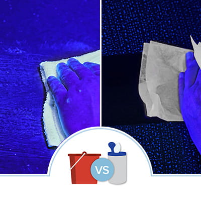 UV light comparison of wiping up a spill with a reusable cloth and red bucket with sanitizing solution vs a disposable sanitizing wipe