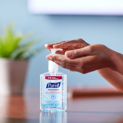 Person using a pump of PURELL hand sanitizer 
