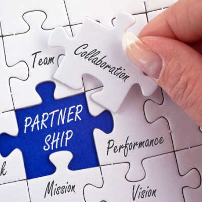 Puzzle pieces showing Partnership and Collaboration written on them