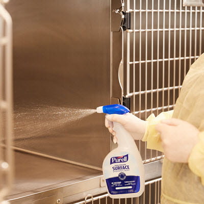 PURELL Surface Spray being used on a dog kennel